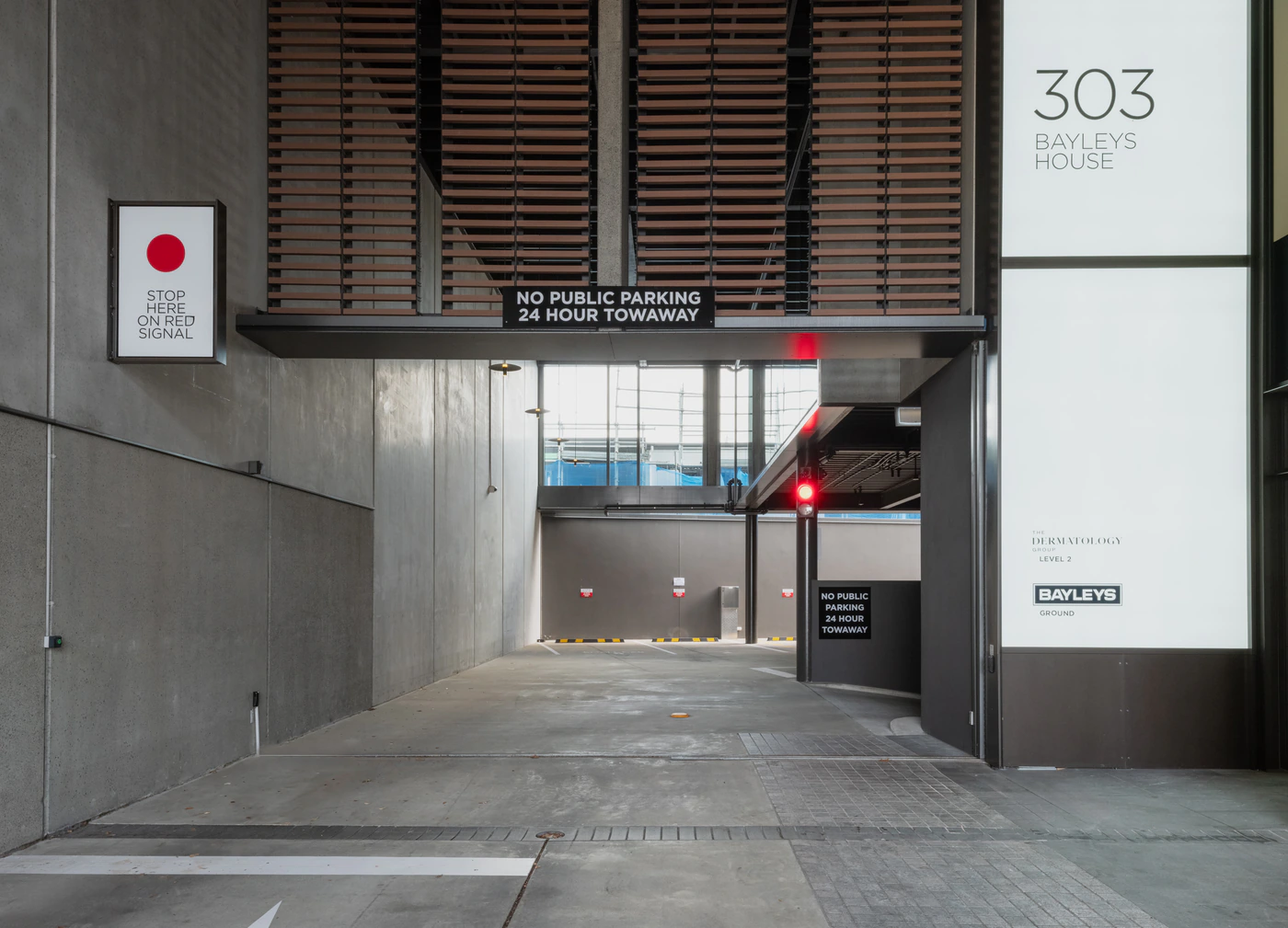303 Remuera Road parking ramp with signal and Dermatology Group signage