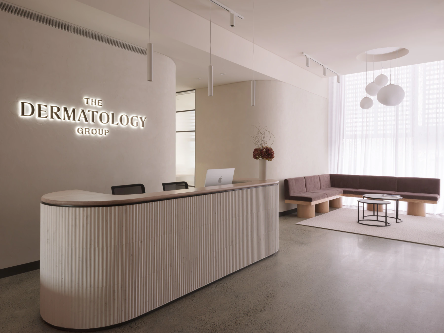 The Dermatology Group reception area with curved desk and waiting lounge